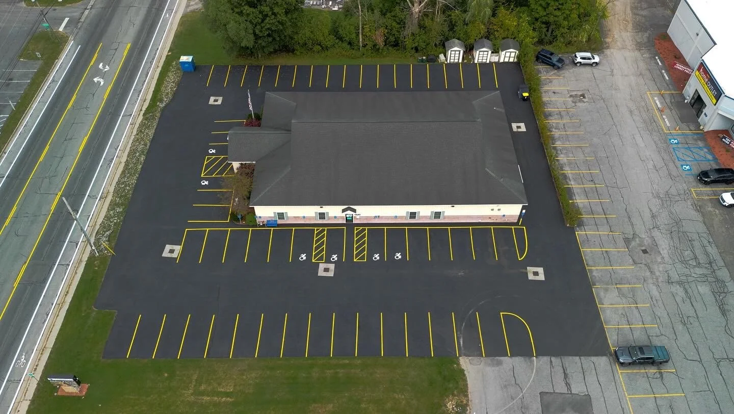 Aerial view of a commercial parking lot freshly striped and sealcoated